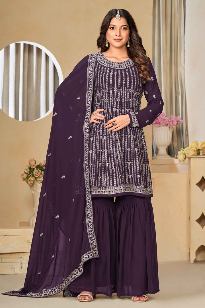 Elegant purple faux georgette salwar kameez featuring heavy thread embroidery and sequins, perfect for festive occasions.