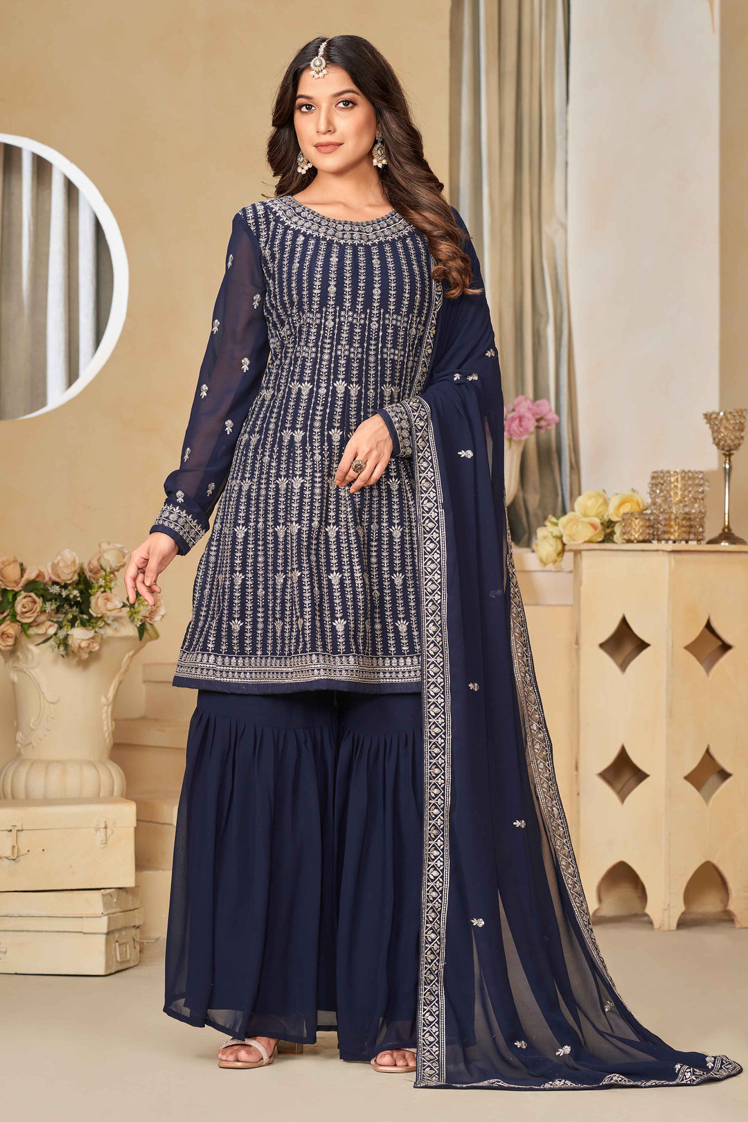 Stunning navy blue salwar kameez in faux georgette with intricate thread embroidery and shimmering sequin work for special events.