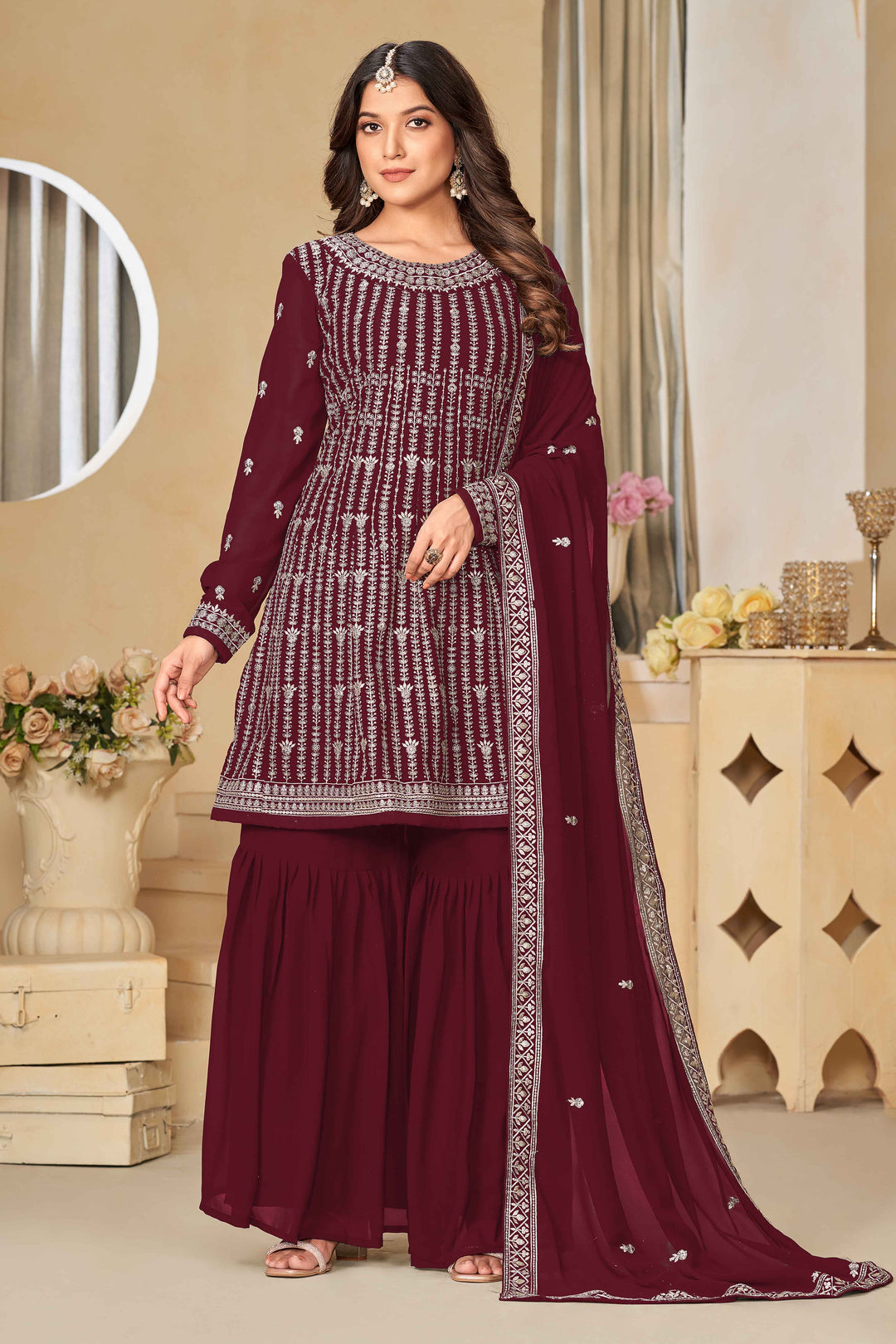 Stunning maroon salwar kameez in faux georgette with intricate thread embroidery and shimmering sequin work for special events.