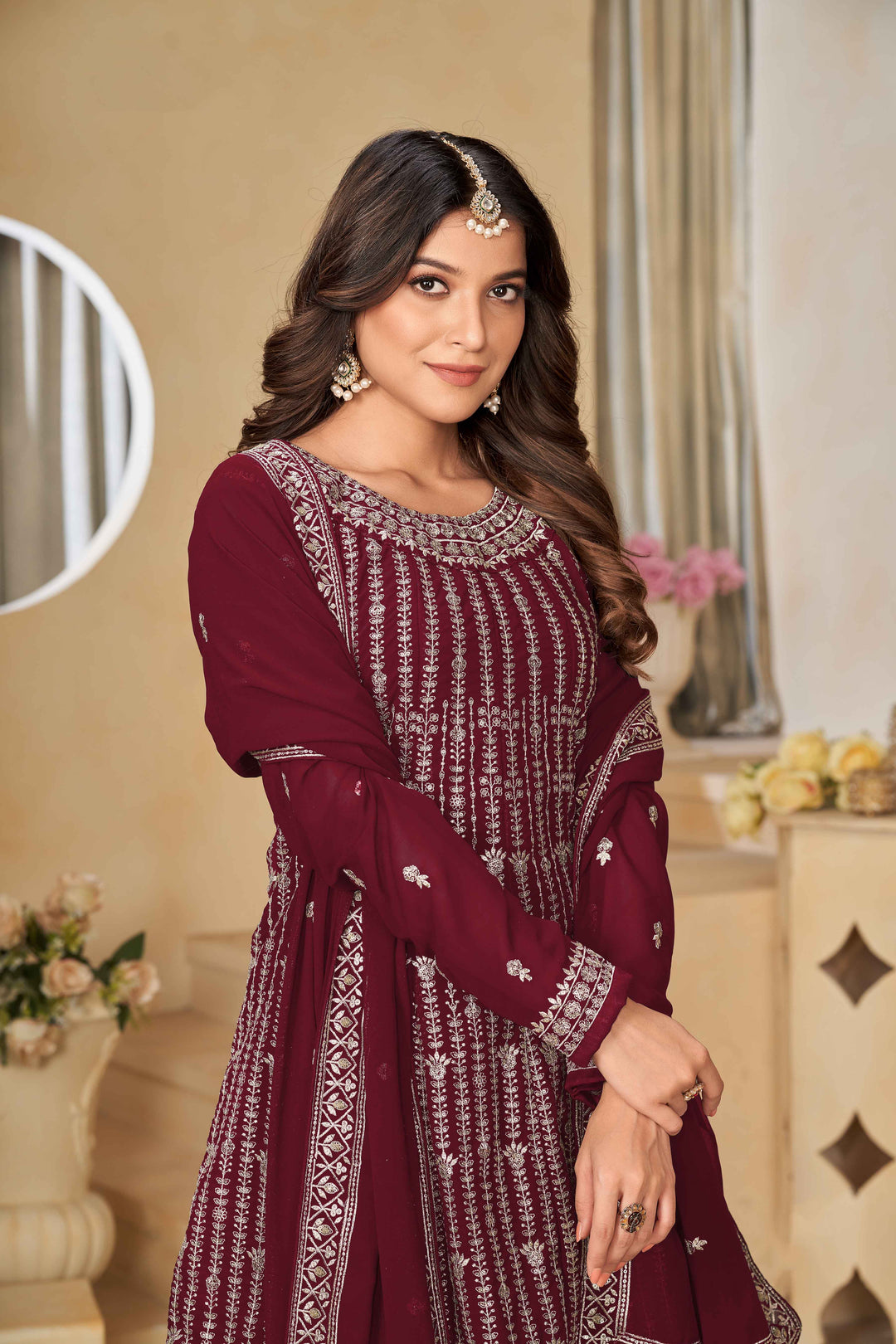 Luxurious maroon faux georgette salwar kameez adorned with exquisite heavy embroidery and sequins, ideal for weddings.