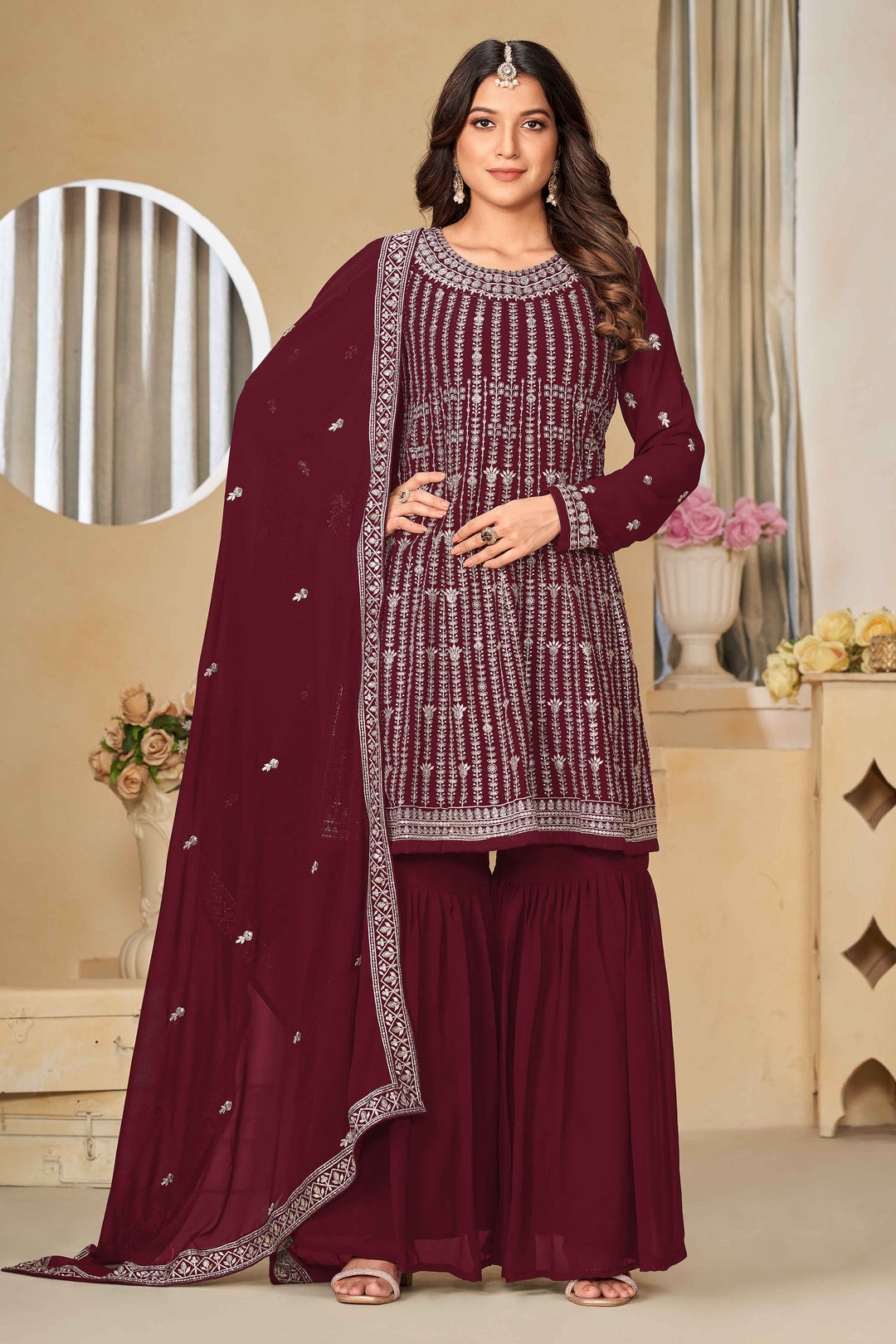 Elegant maroon faux georgette salwar kameez featuring heavy thread embroidery and sequins, perfect for festive occasions.