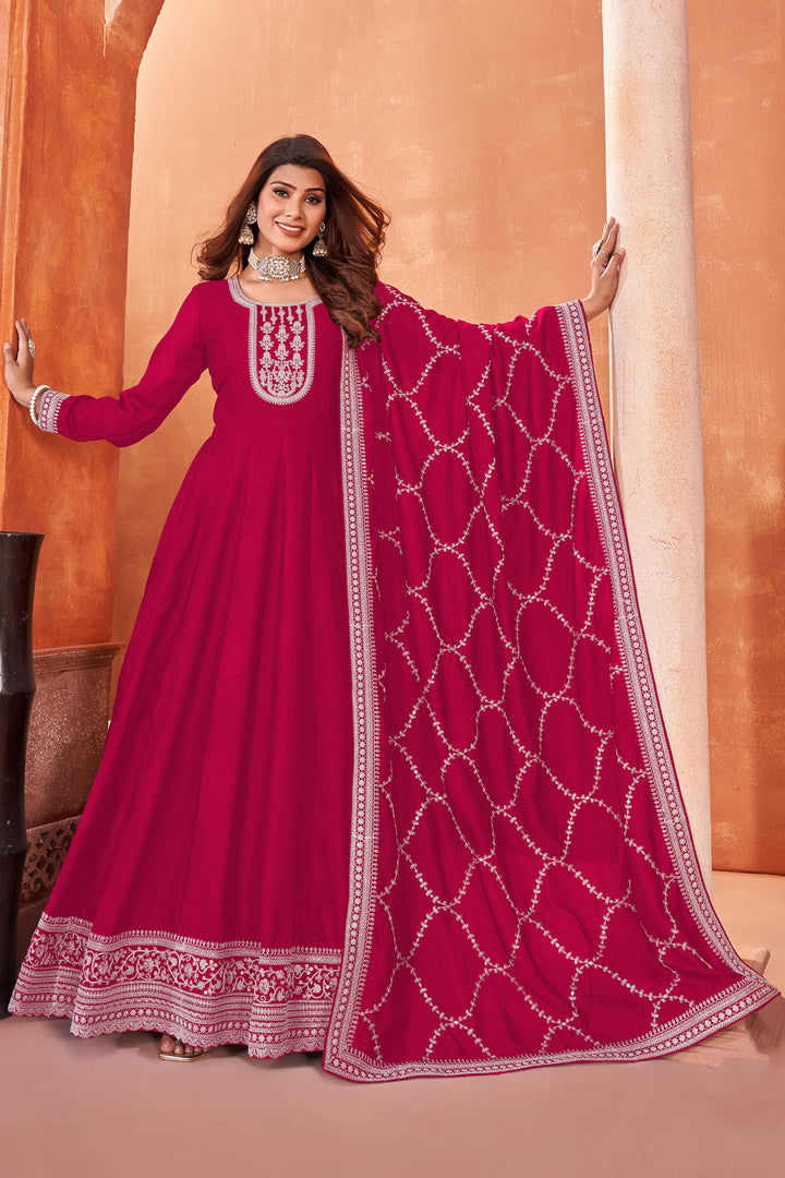 Stunning rani pink salwar kameez in art silk with intricate thread embroidery and shimmering sequin work for festive events.