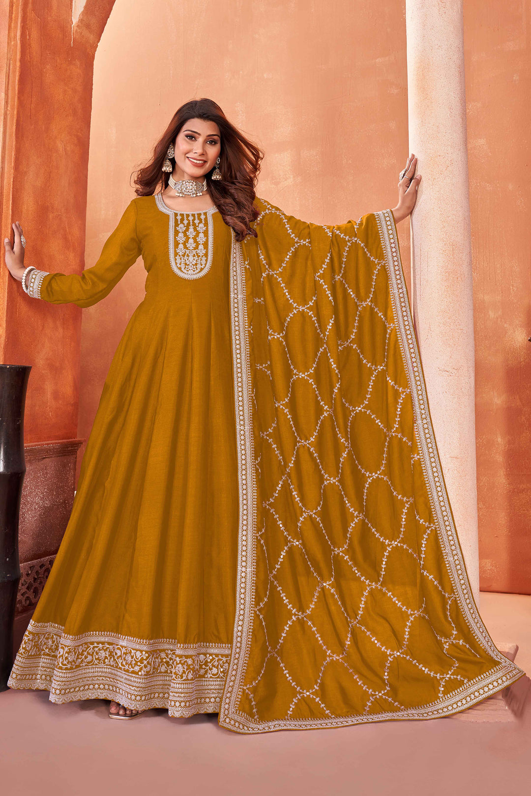 Stunning mustard salwar kameez in art silk with intricate thread embroidery and shimmering sequin work for festive events.