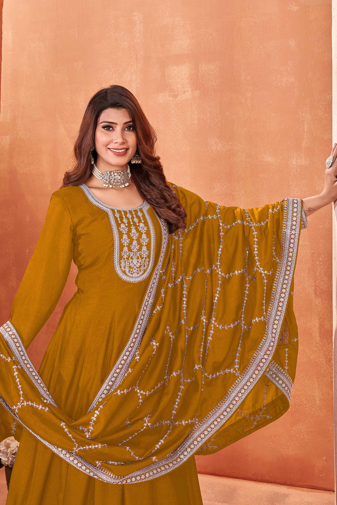 Luxurious mustard art silk salwar kameez adorned with exquisite heavy embroidery and sequins, ideal for weddings.