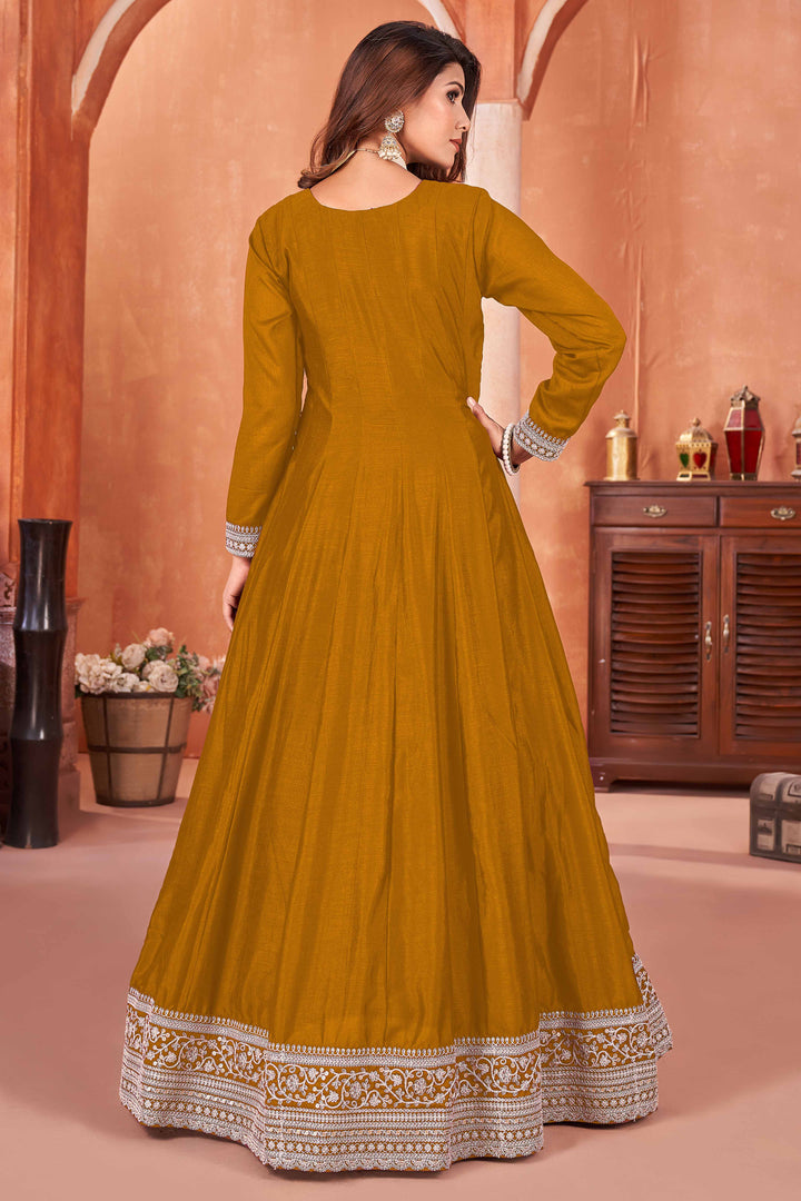 Beautiful mustard salwar kameez crafted from art silk, showcasing intricate heavy thread and sequin embellishments.