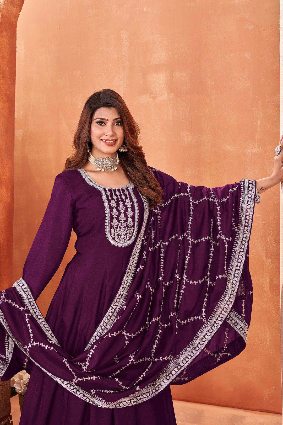 Luxurious wine art silk salwar kameez adorned with exquisite heavy embroidery and sequins, ideal for weddings.