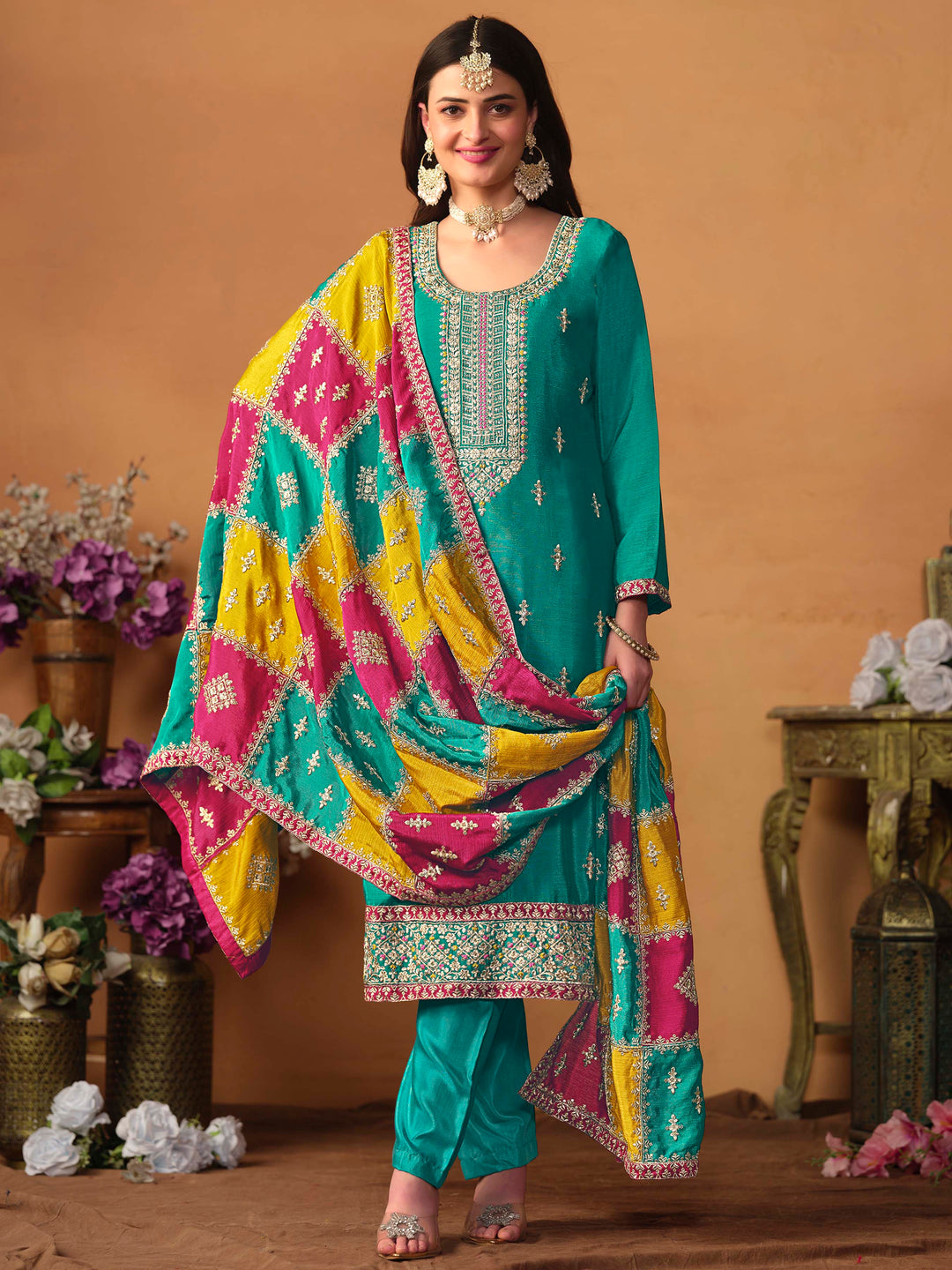 Luxurious teal green chinon silk salwar kameez adorned with exquisite heavy embroidery and sequins, ideal for weddings.