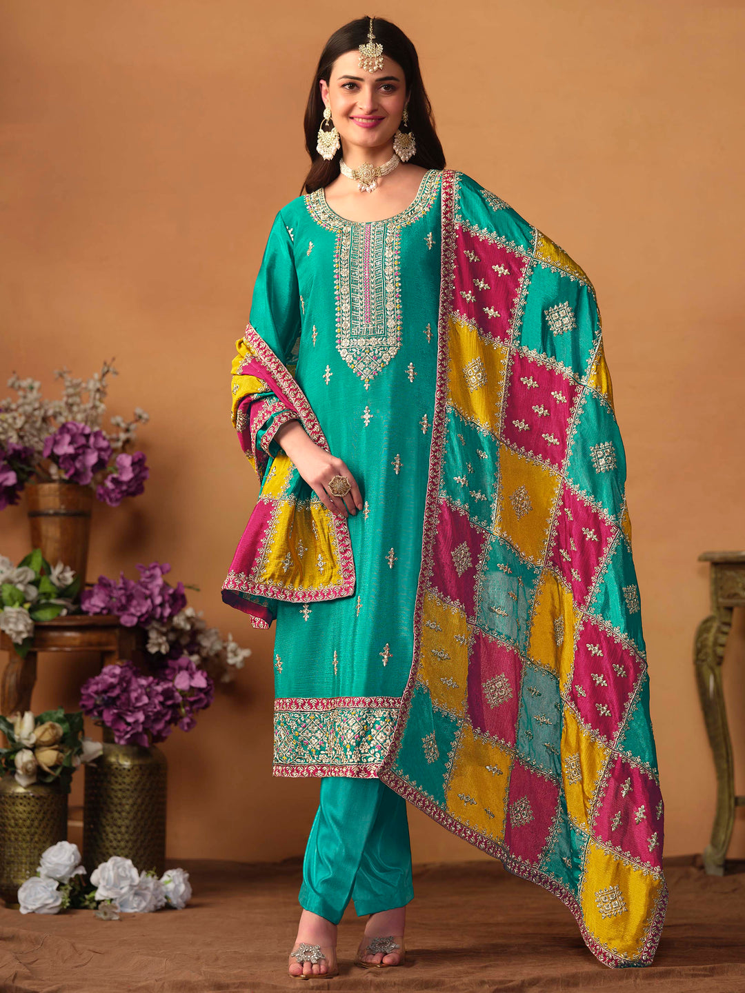 Elegant teal green chinon silk salwar kameez featuring heavy thread embroidery and sequins, perfect for special occasions.