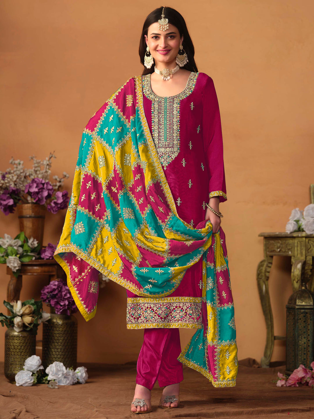 Luxurious rani pink chinon silk salwar kameez adorned with exquisite heavy embroidery and sequins, ideal for weddings.