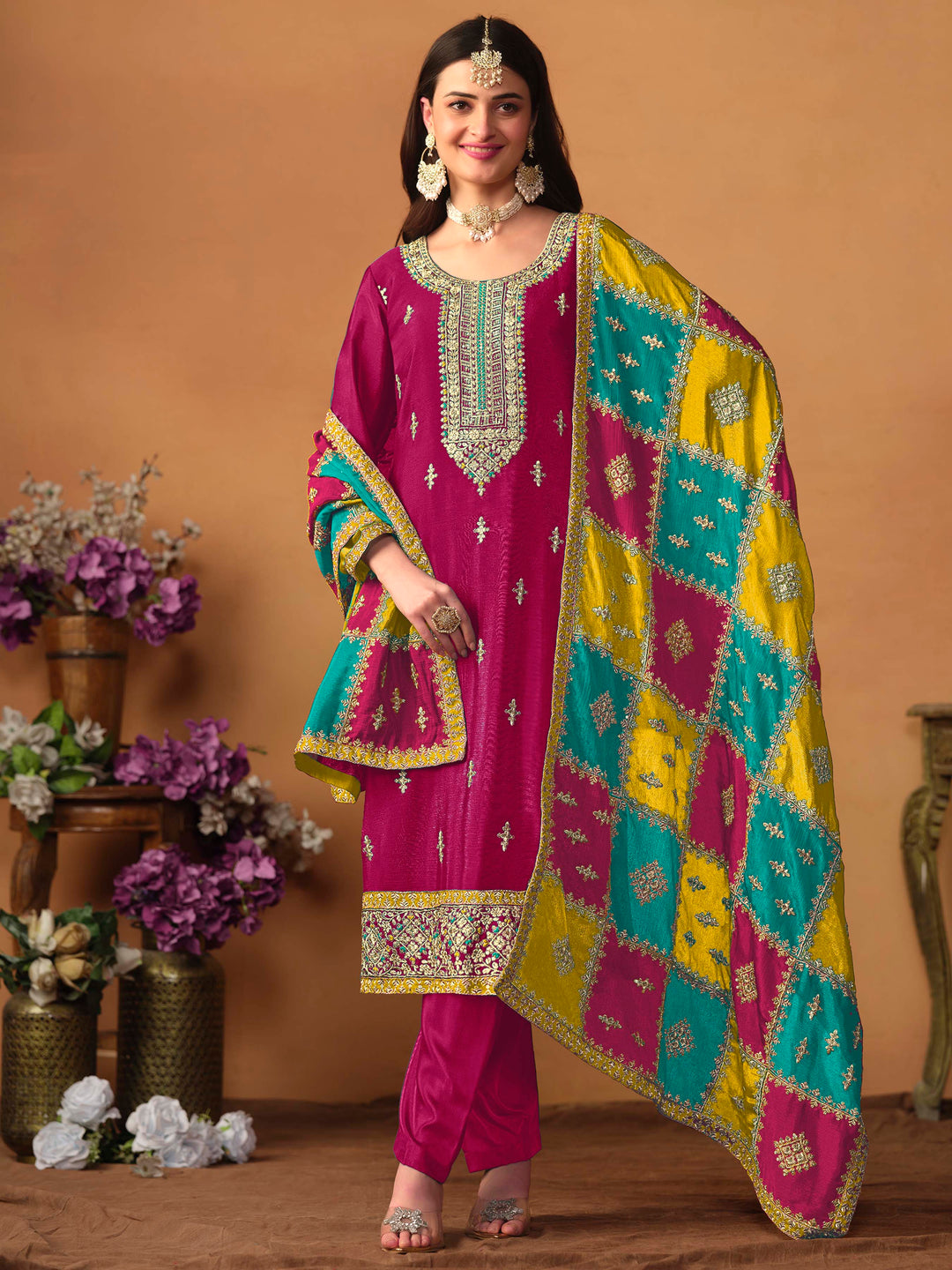 Elegant rani pink chinon silk salwar kameez featuring heavy thread embroidery and sequins, perfect for festive occasions.