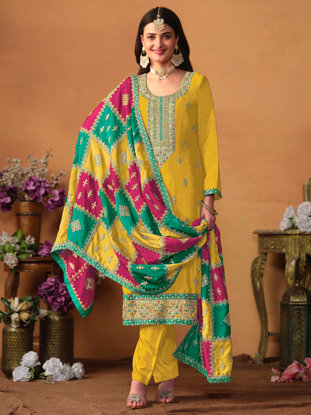 Luxurious mustard chinon silk salwar kameez adorned with exquisite heavy embroidery and sequins, ideal for weddings.