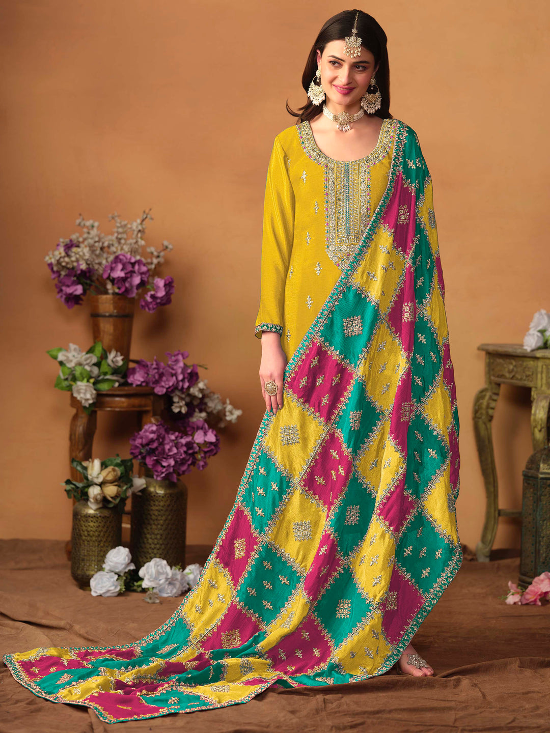 Beautiful mustard salwar kameez crafted from chinon silk, showcasing intricate heavy thread and sequin embellishments.