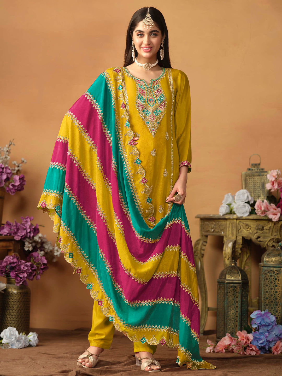 Stunning mustard chinon silk salwar kameez featuring heavy thread embroidery and sequins, perfect for festive occasions.