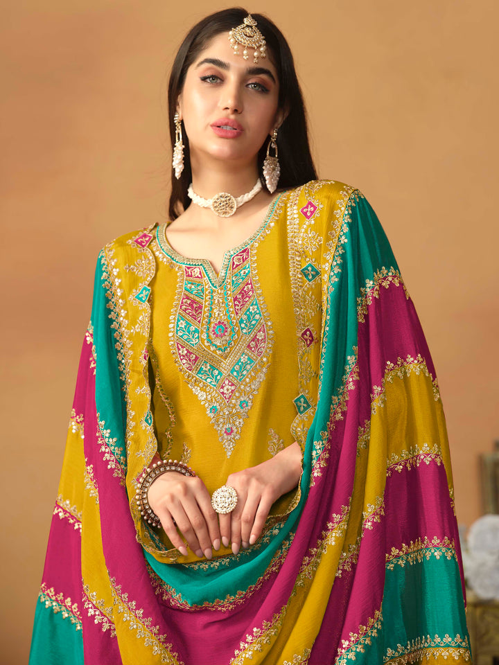 Luxurious mustard chinon silk salwar kameez adorned with exquisite heavy embroidery and sequins, ideal for weddings.