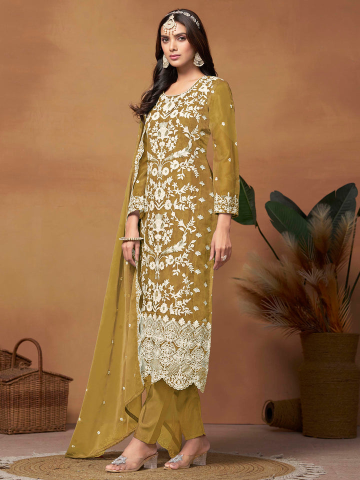 Luxurious mustard soft organza salwar kameez adorned with exquisite heavy embroidery and sequins, ideal for weddings.