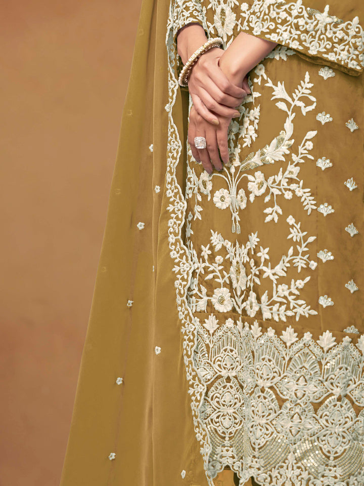 Beautiful mustard salwar kameez crafted from soft organza, showcasing intricate heavy thread and sequin embellishments.