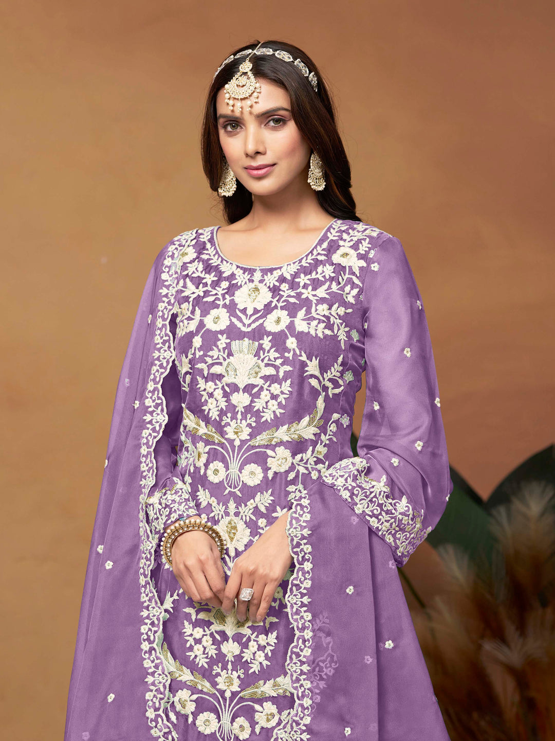 Elegant lavender salwar kameez in soft organza with intricate thread embroidery and shimmering sequin work for special events.