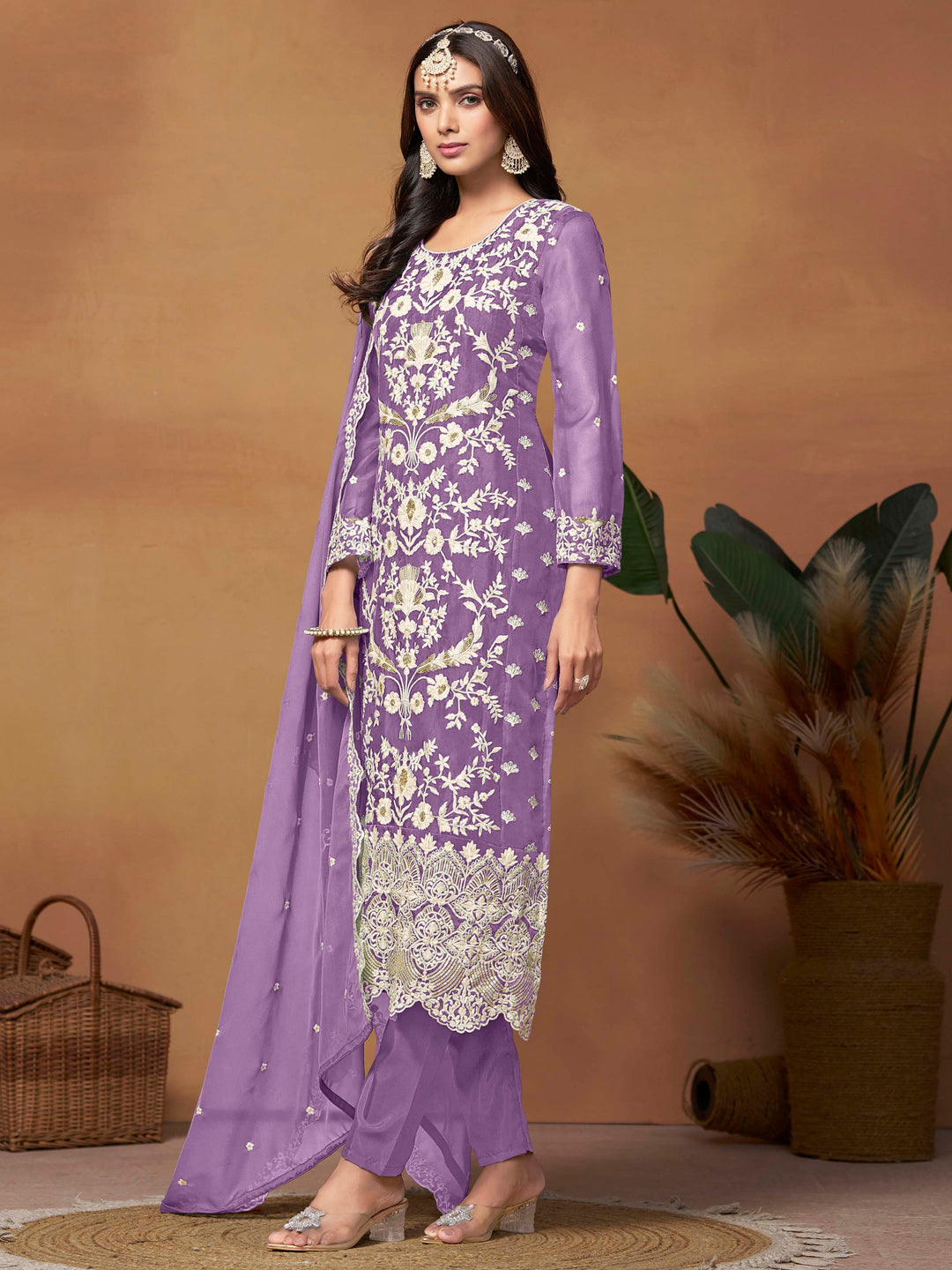 Luxurious lavender soft organza salwar kameez adorned with exquisite heavy embroidery and sequins, ideal for weddings.