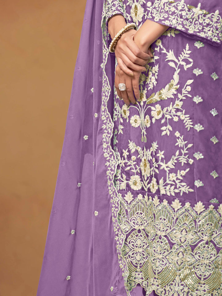 Beautiful lavender salwar kameez crafted from soft organza, showcasing intricate heavy thread and sequin embellishments.