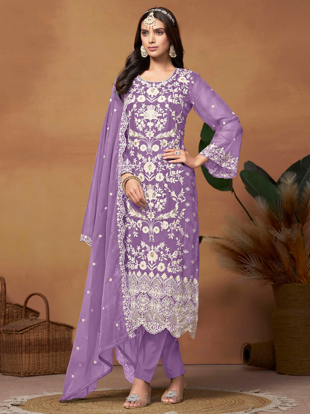 Stunning lavender soft organza salwar kameez featuring heavy thread embroidery and sequins, perfect for festive occasions.