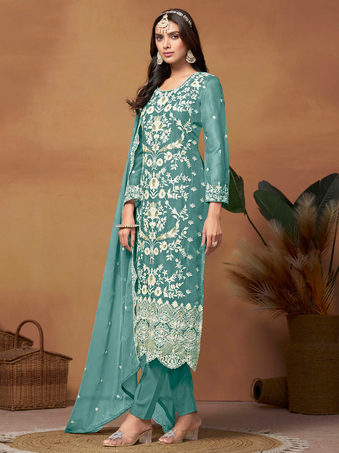 Luxurious teal soft organza salwar kameez adorned with exquisite heavy embroidery and sequins, ideal for weddings.