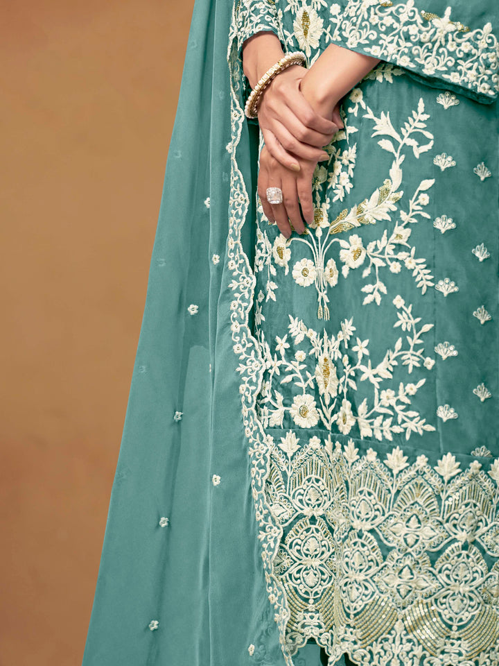 Beautiful teal salwar kameez crafted from soft organza, showcasing intricate heavy thread and sequin embellishments.