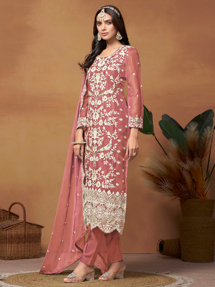 Luxurious dusty pink soft organza salwar kameez adorned with exquisite heavy embroidery and sequins, ideal for weddings.