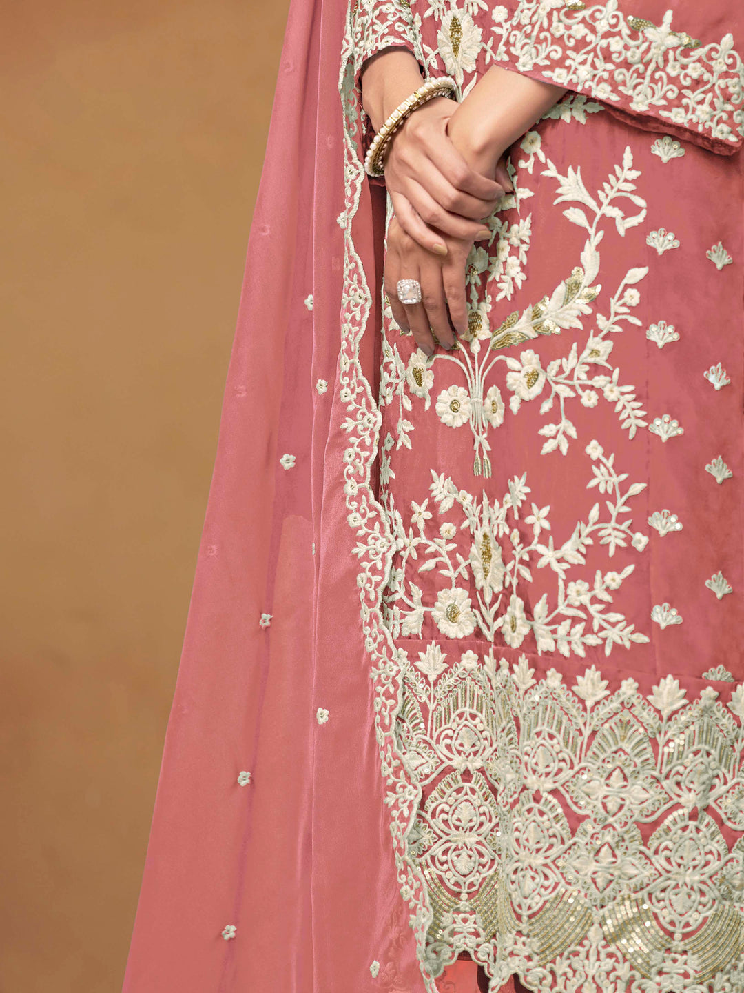 Beautiful dusty pink salwar kameez crafted from soft organza, showcasing intricate heavy thread and sequin embellishments.