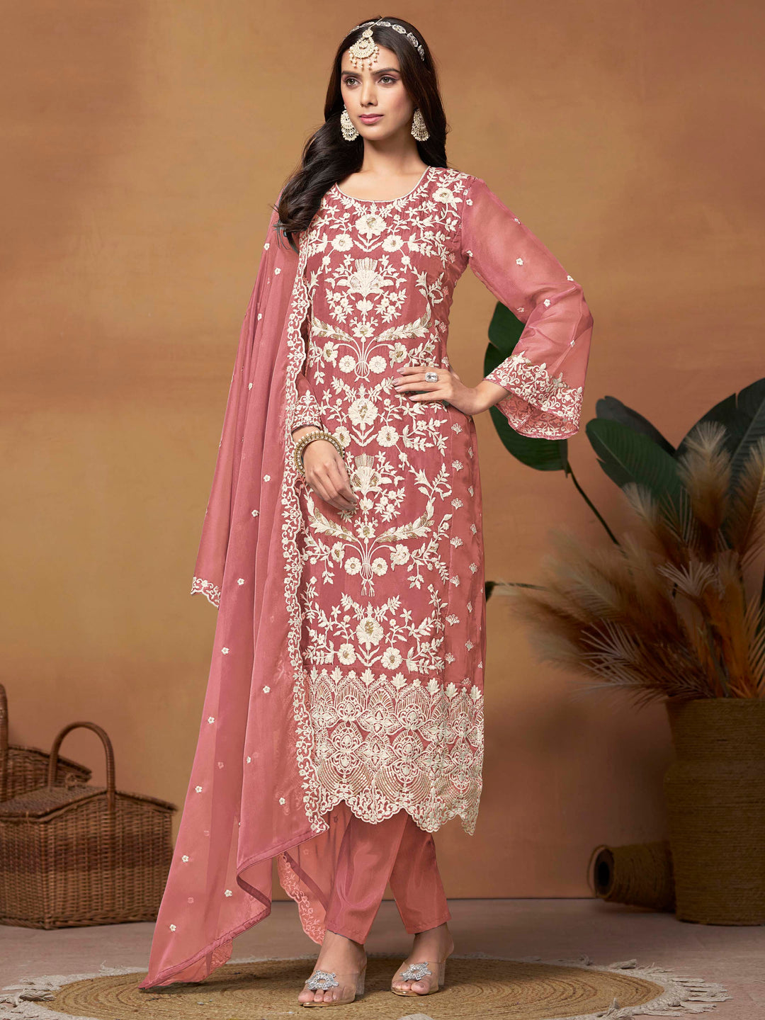 Stunning dusty pink soft organza salwar kameez featuring heavy thread embroidery and sequins, perfect for festive occasions.