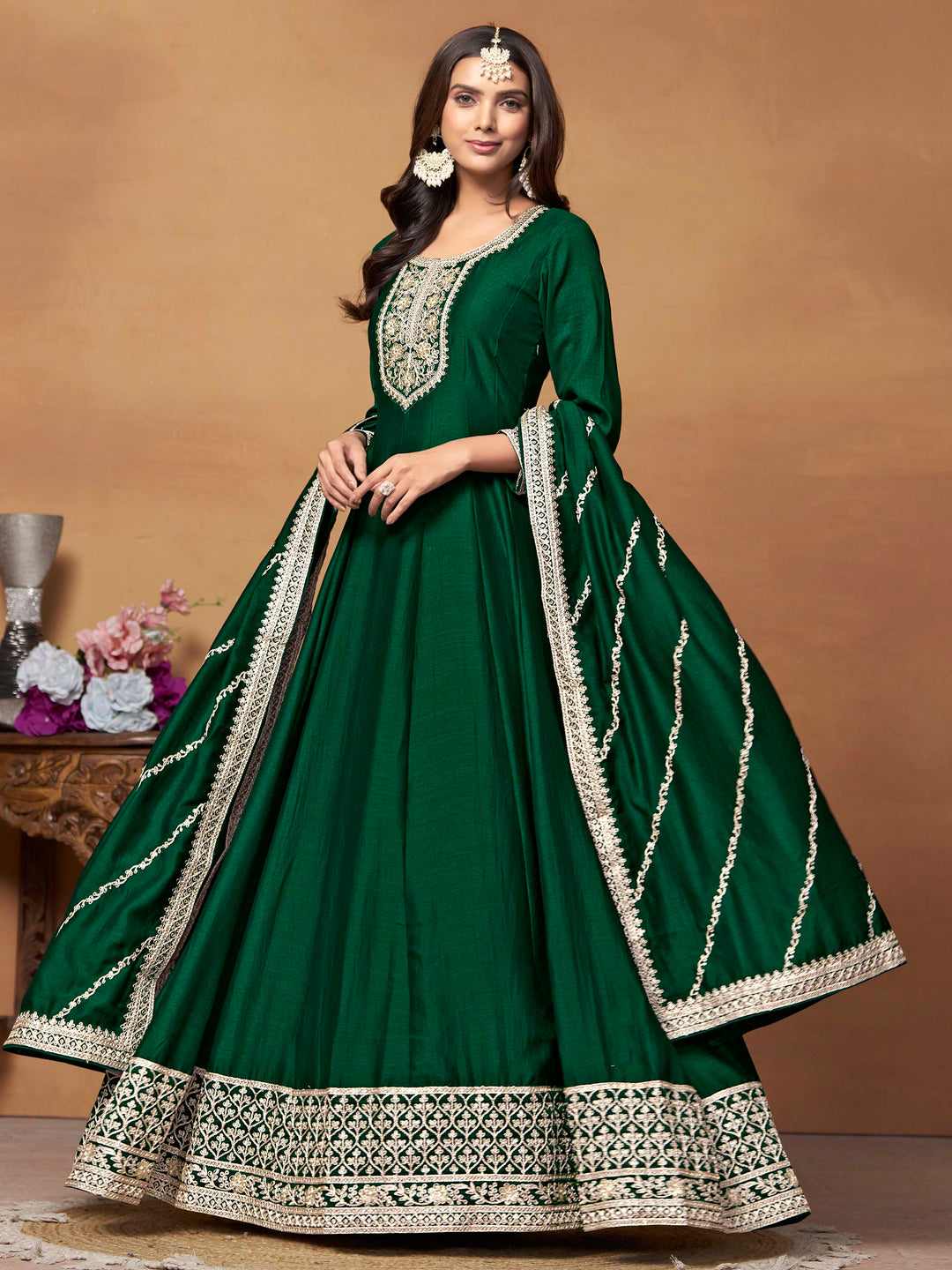 Stunning dark green salwar kameez in art silk with intricate thread embroidery and shimmering sequin work for festive events.