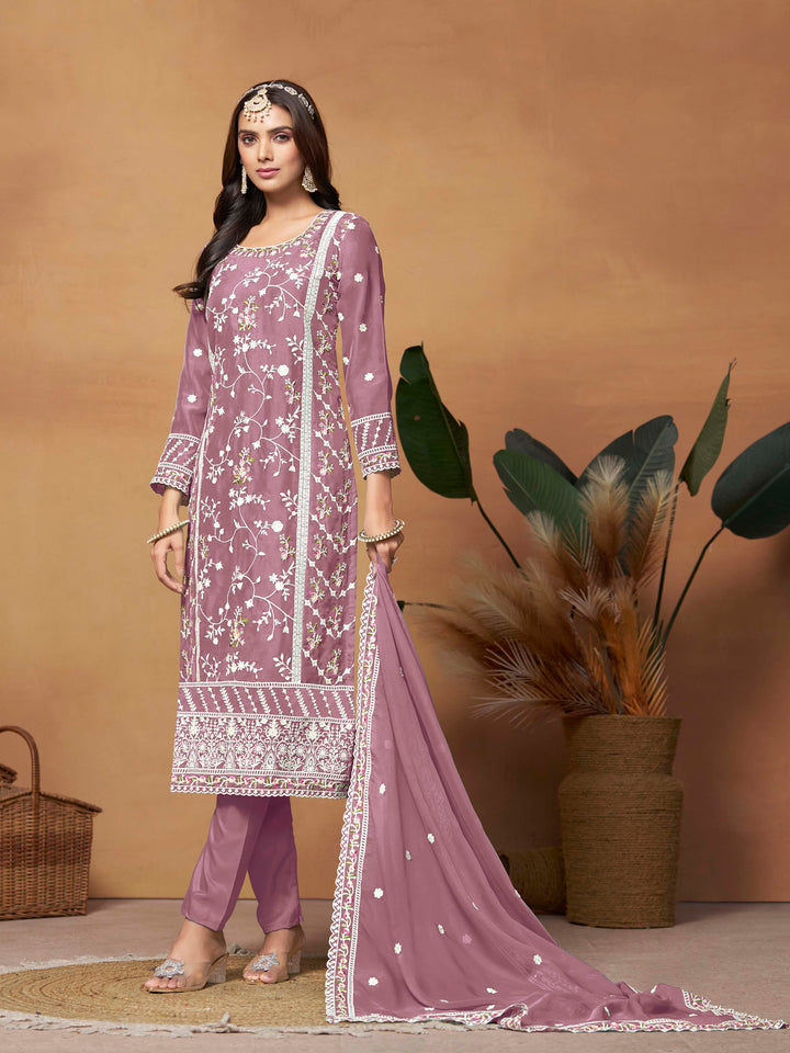 Elegant onion pink salwar kameez in soft organza with intricate thread embroidery and shimmering sequin work for festive events.