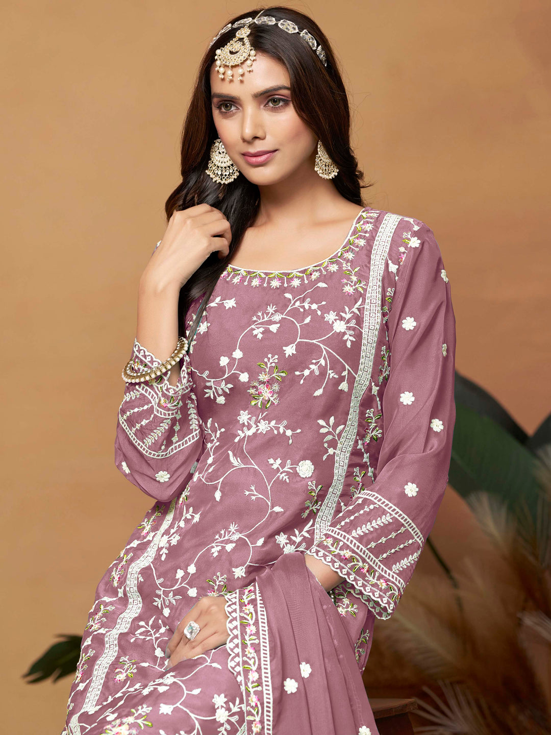 Luxurious onion pink soft organza salwar kameez adorned with exquisite heavy embroidery and sequins, ideal for weddings.