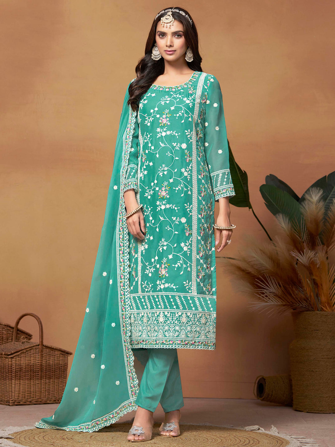 Elegant turquoise soft organza salwar kameez featuring heavy thread embroidery and sequins, perfect for festive occasions.