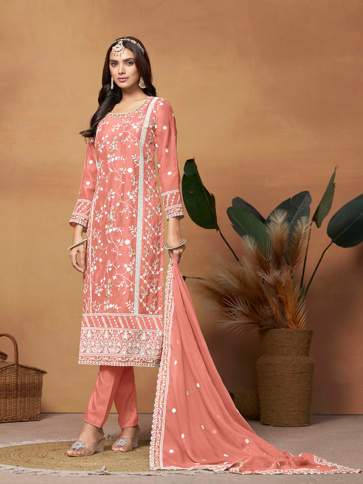 Elegant salmon salwar kameez in soft organza with intricate thread embroidery and shimmering sequin work for festive events.