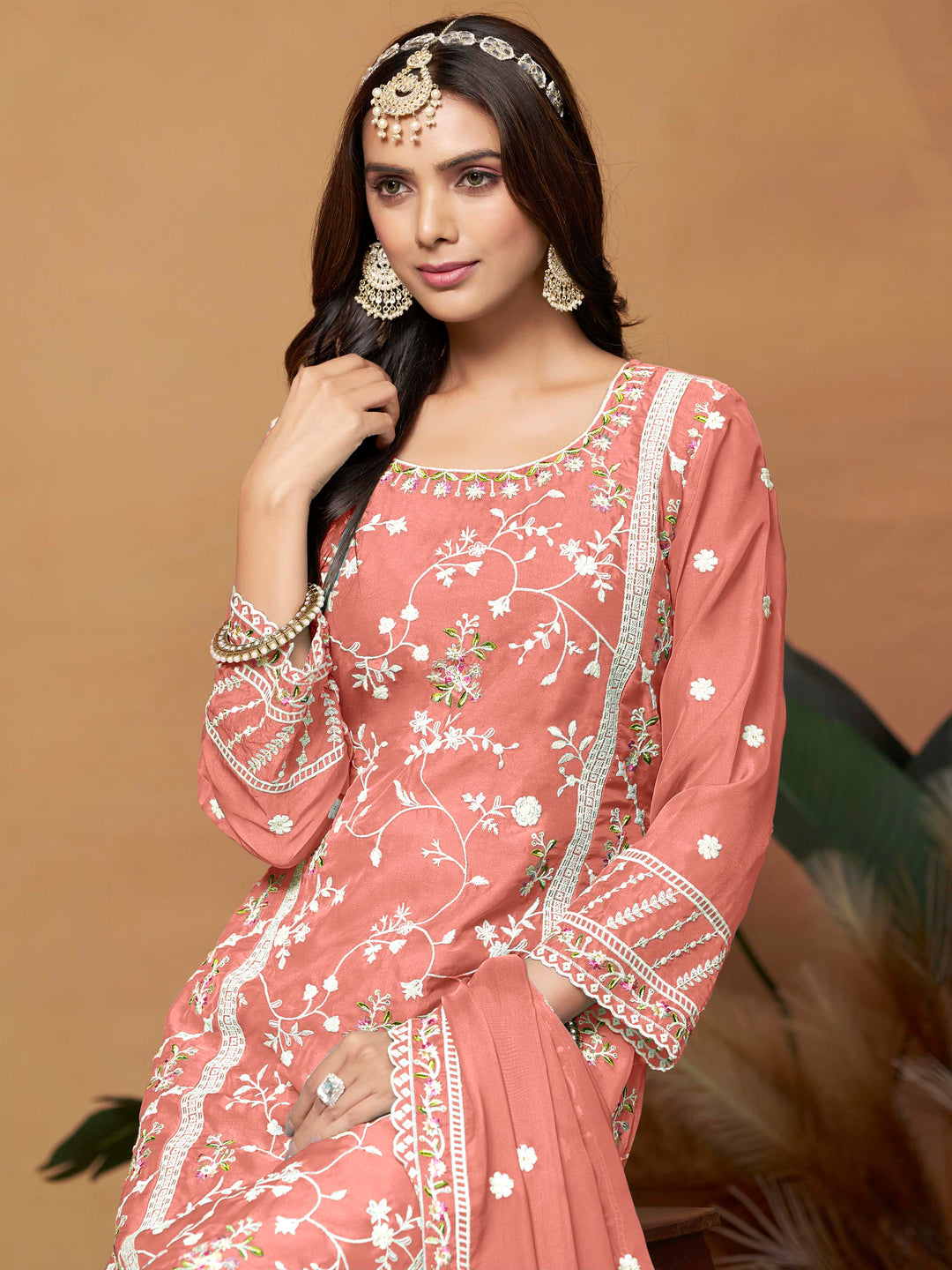 Luxurious salmon soft organza salwar kameez adorned with exquisite heavy embroidery and sequins, ideal for weddings.