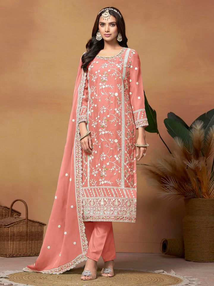 Stunning salmon soft organza salwar kameez featuring heavy thread embroidery and sequins, perfect for special occasions.