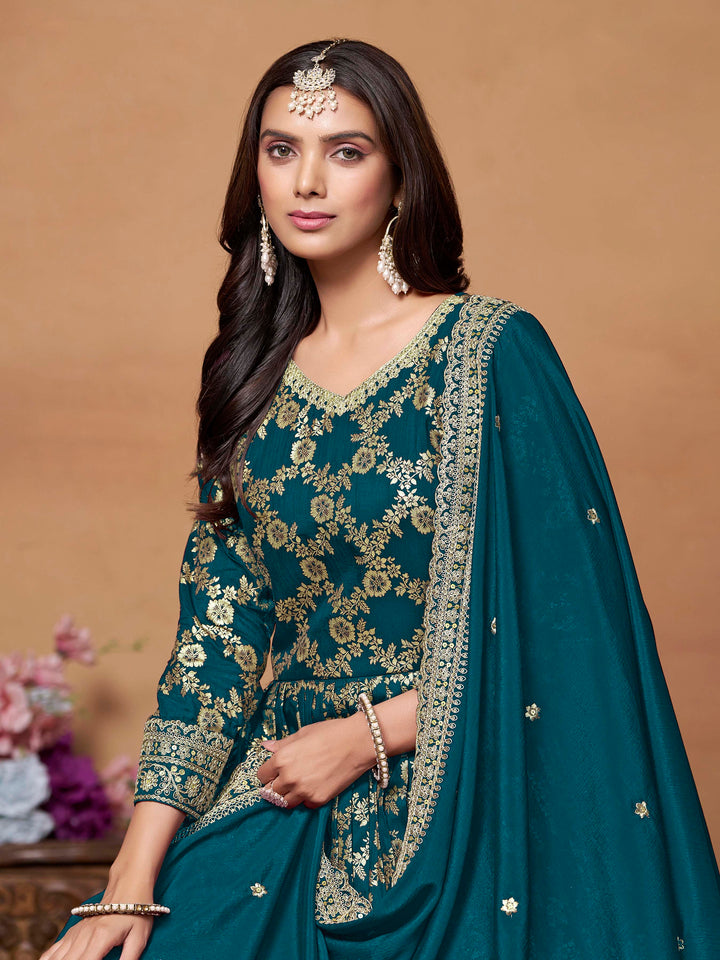 Stunning teal blue salwar kameez in dola jacquard with exquisite thread embroidery, ideal for special events.