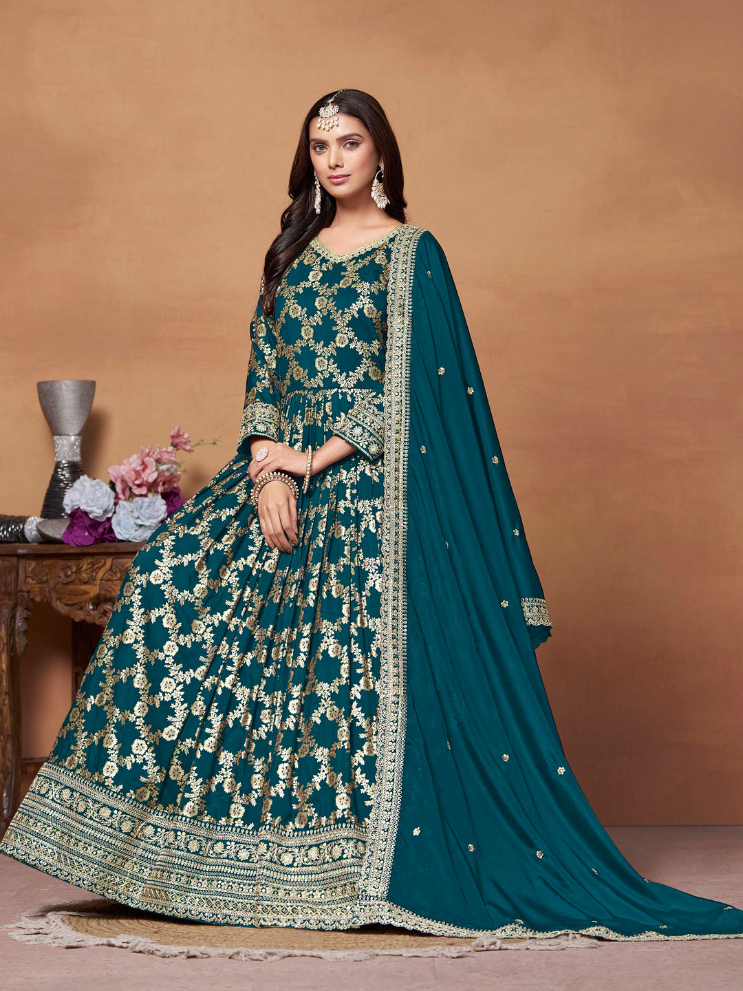 Beautiful teal blue salwar kameez crafted from dola jacquard, showcasing intricate thread embroidery and a stylish design.