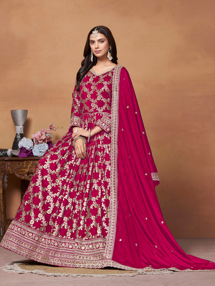 Beautiful rani pink salwar kameez crafted from dola jacquard, showcasing intricate thread embroidery and a stylish design.