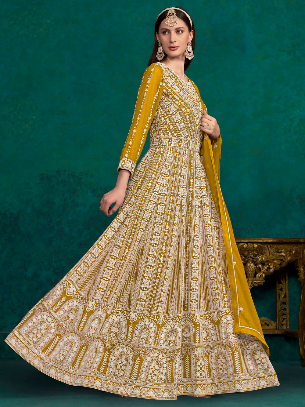 Stunning mustard salwar kameez in faux georgette with intricate embroidery and shimmering sequin work for special events.