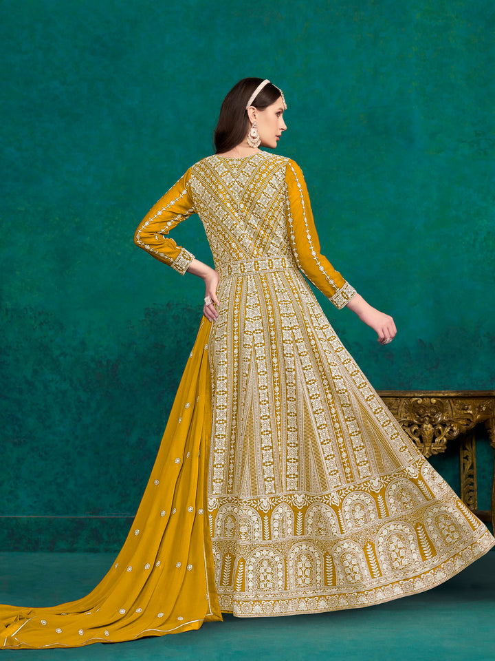 Beautiful mustard salwar kameez crafted from faux georgette, showcasing intricate heavy thread and sequin embellishments.