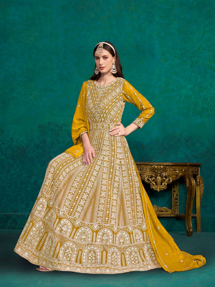 Vibrant mustard faux georgette salwar kameez adorned with heavy thread embroidery and shimmering sequins for elegant occasions.