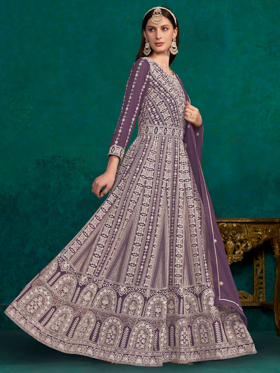 Stunning purple salwar kameez in faux georgette with intricate heavy embroidery and shimmering sequin work for special events.