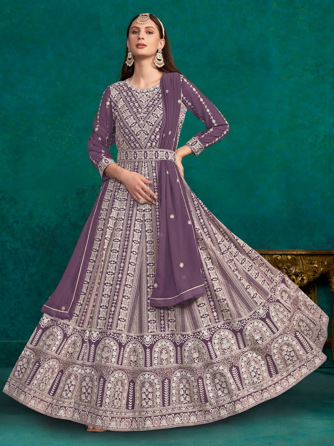 Elegant purple faux georgette salwar kameez featuring heavy thread embroidery and sequins, perfect for festive occasions.