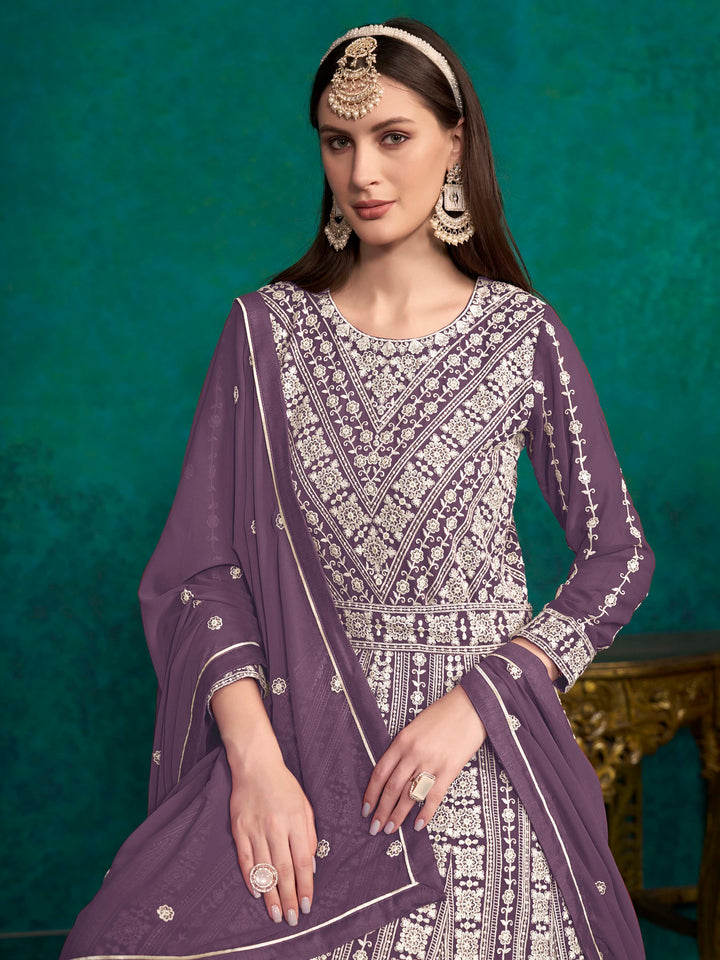 Luxurious purple faux georgette salwar kameez adorned with exquisite heavy embroidery and sequins, ideal for weddings.