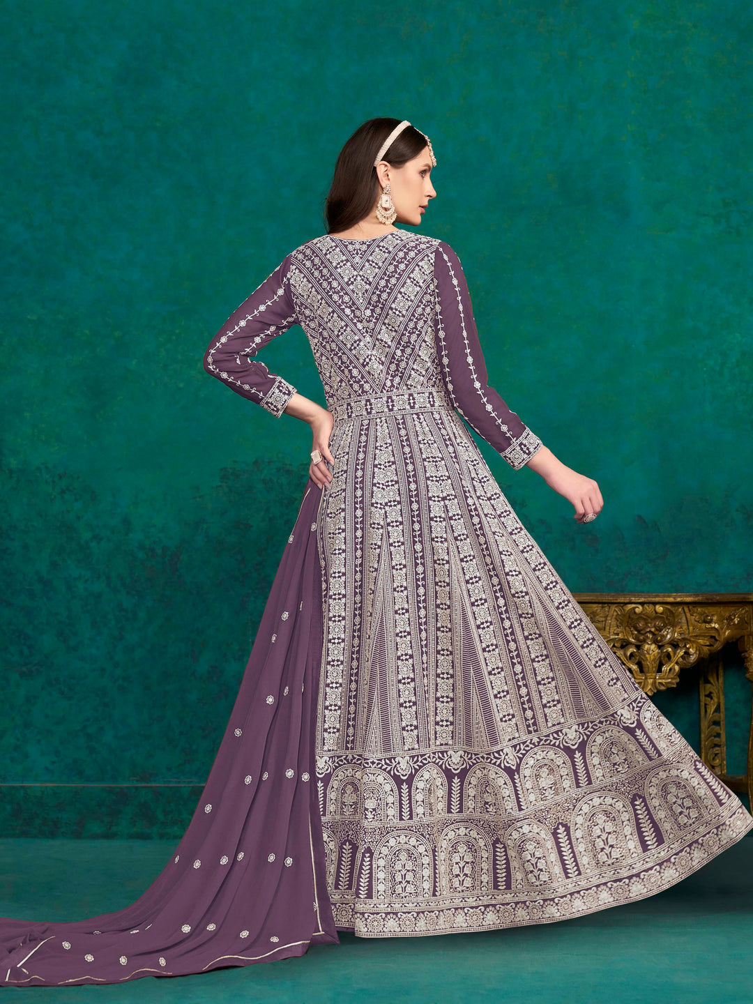 Beautiful purple salwar kameez crafted from faux georgette, showcasing intricate heavy thread and sequin embellishments.