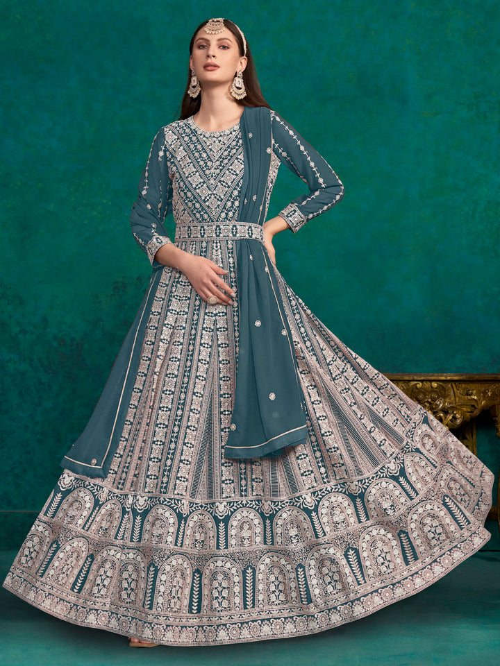 Elegant teal blue faux georgette salwar kameez featuring heavy thread embroidery and sequins, perfect for festive occasions.