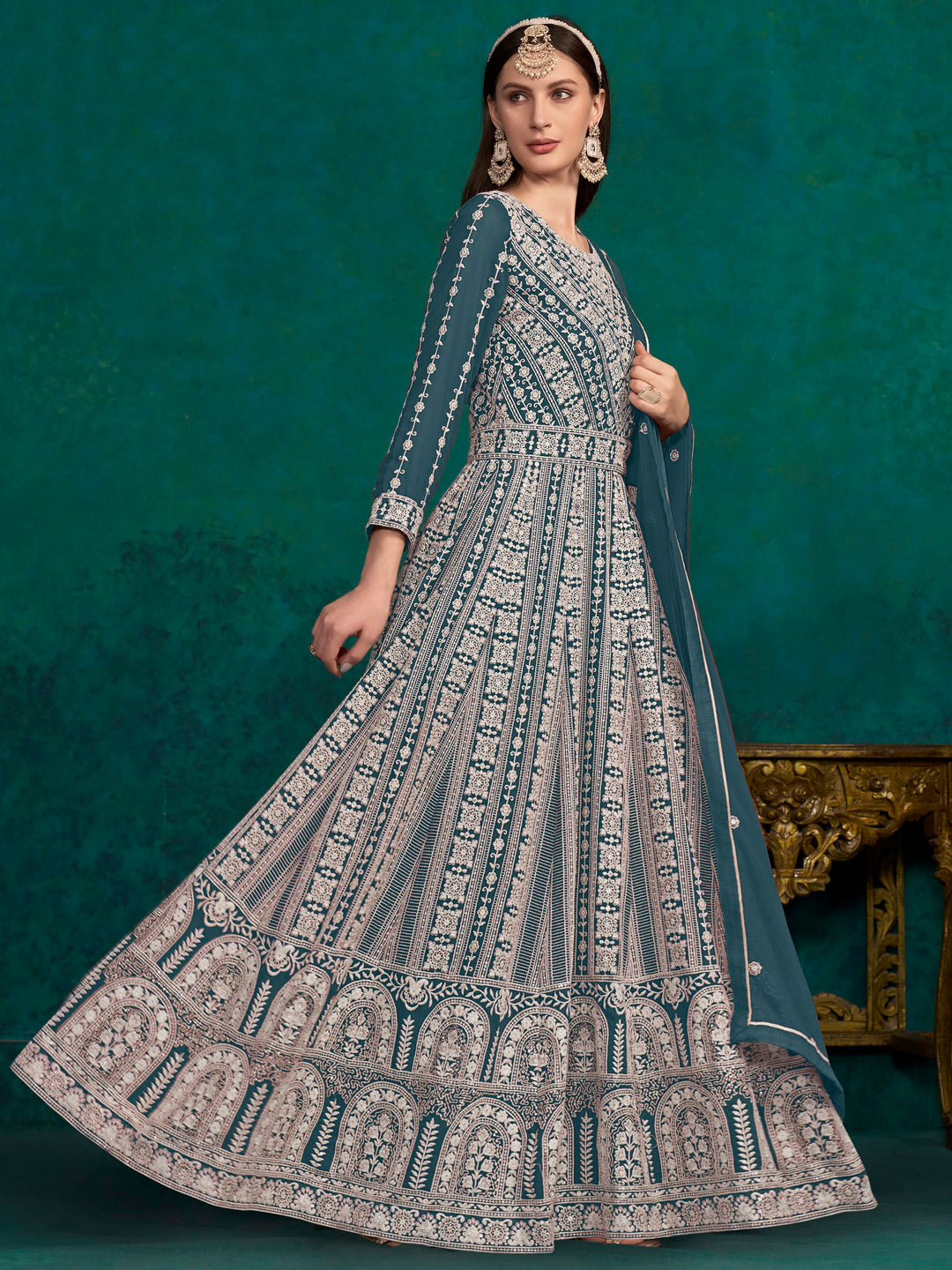 Beautiful teal blue faux georgette salwar kameez adorned with intricate embroidery and sequins, ideal for special events.