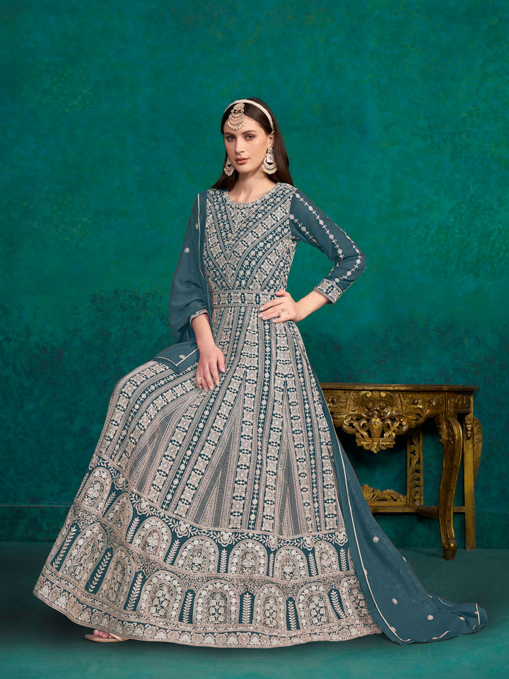 Beautiful teal blue faux georgette salwar kameez showcasing exquisite heavy thread embroidery and sequins, perfect for weddings.