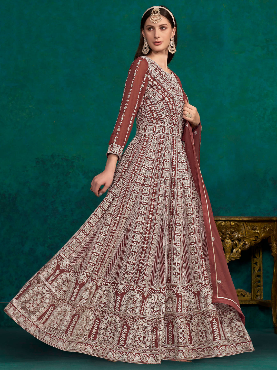 Stylish brick brown faux georgette salwar kameez adorned with beautiful heavy thread embroidery and sequins for festive wear.